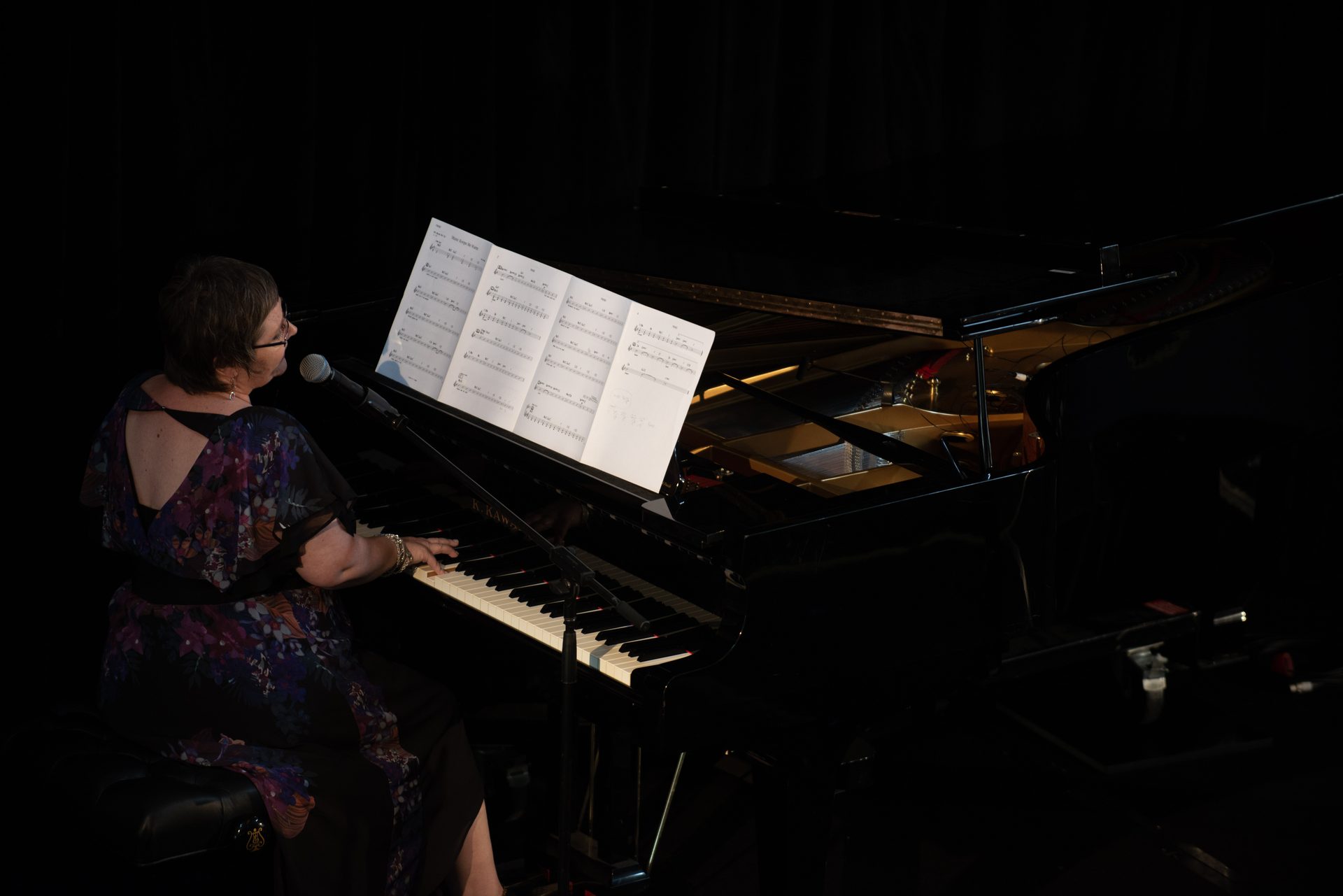 A grand piano performer on stage