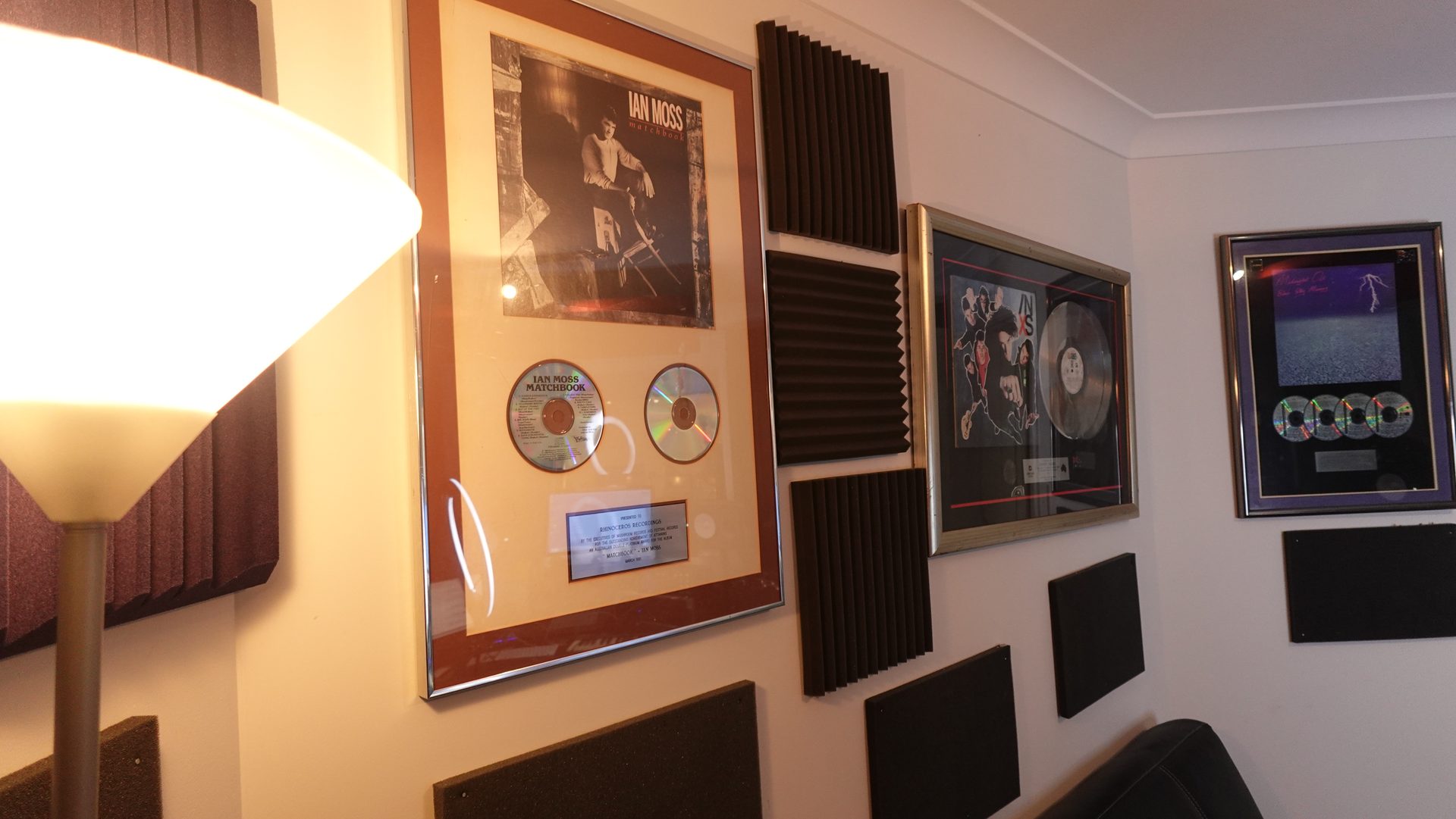 A studio wall lined with gold and platinum records